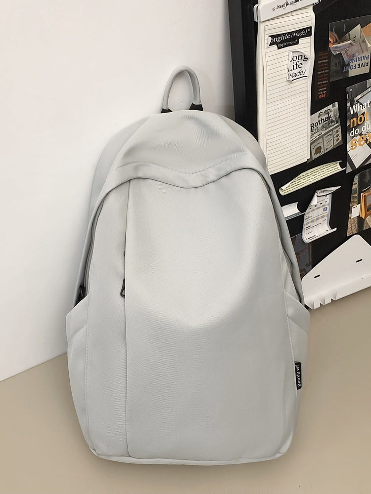 Large capacity school bag male high school student Korean version trendy travel backpack female junior high school student simple solid color backpack